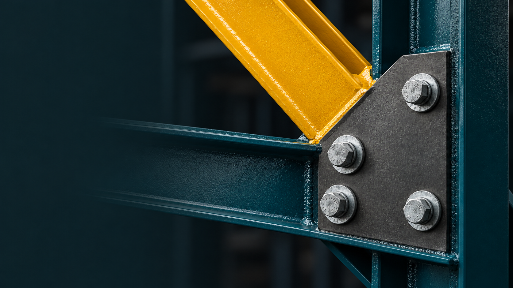 A petrol teal steel connection with galvanized bolts, a graphite plate and a yellow structural profile